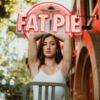 photo of woman posing in front of neon sign that says "fat pie"