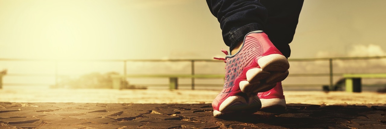 colorful photo close up of person's feet in running shoes