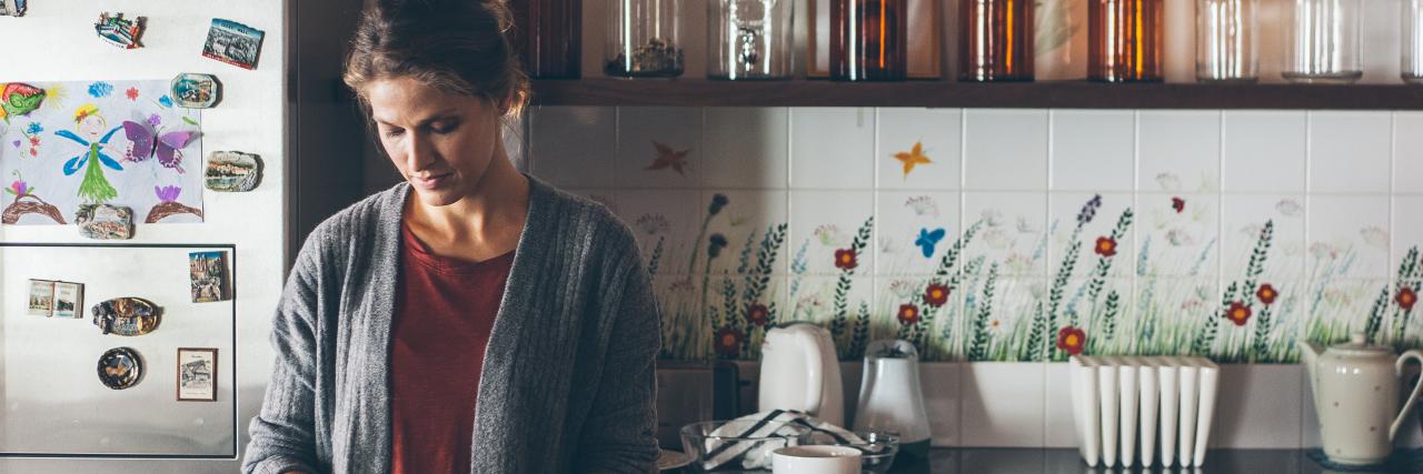 Gadgets to Make Cooking With Chronic Illness Easier photo of woman in large kitchen cooking at counter