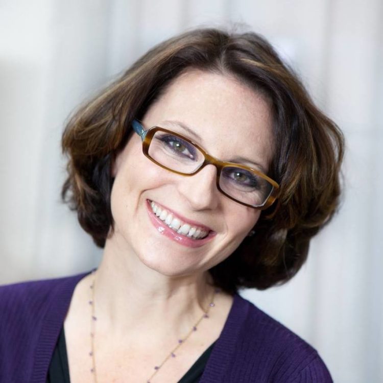 Meg Cabot wearing glasses purple shirt