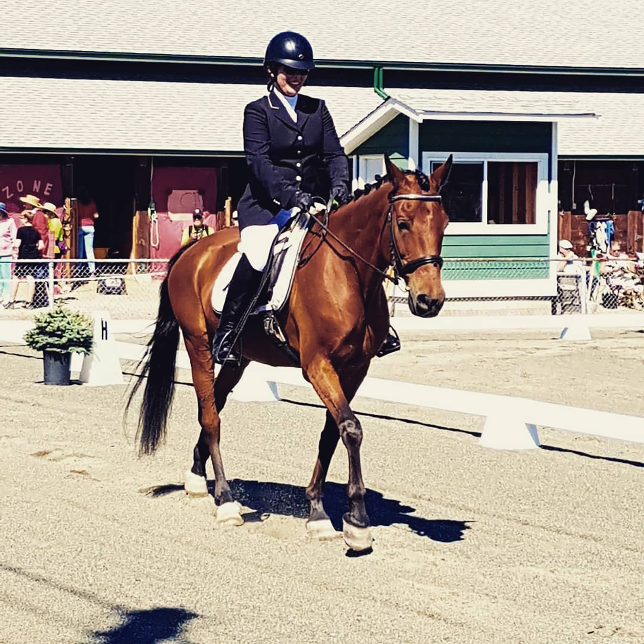 Kelsey riding a brown horse.