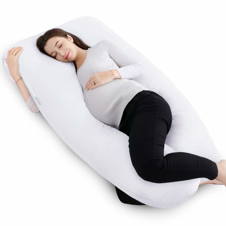 woman lying in white pregnancy pillow