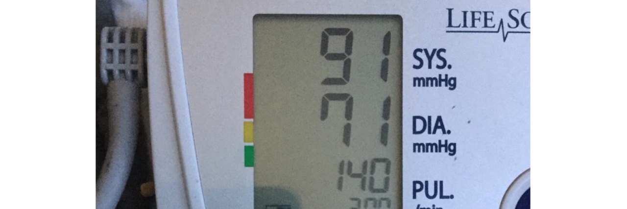 blood pressure monitor showing a BP of 91 over 71