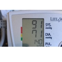 blood pressure monitor showing a BP of 91 over 71