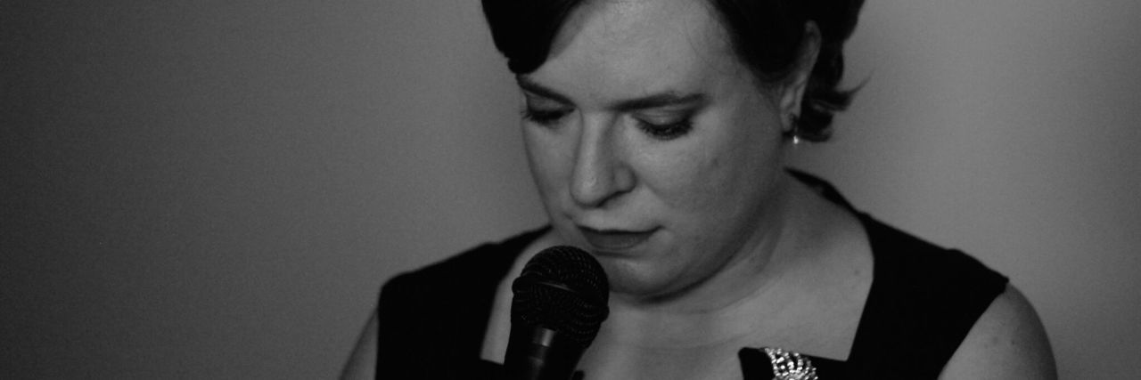 Voice Movement Therapy for Chronic Pain and Muscle Tension black and white close up photo of woman with closed eyes and microphone