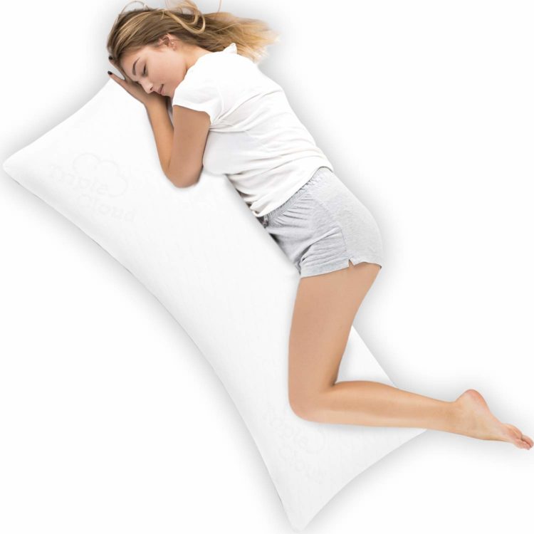 woman in shorts with blonde hair hugging white body pillow