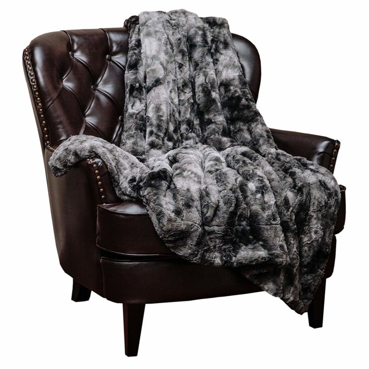 grey blanket on brown chair
