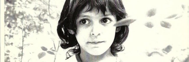The author as a young girl, she has shoulder length dark hair