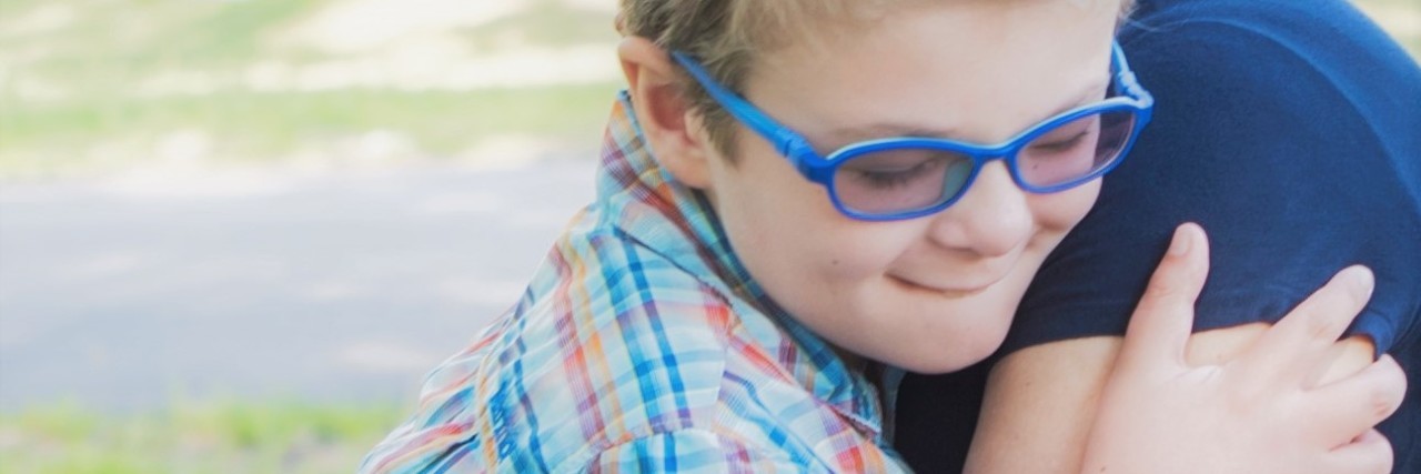 Parenting a Child With Synder-Robinson Syndrome: Finding a Cure the author hugging her child