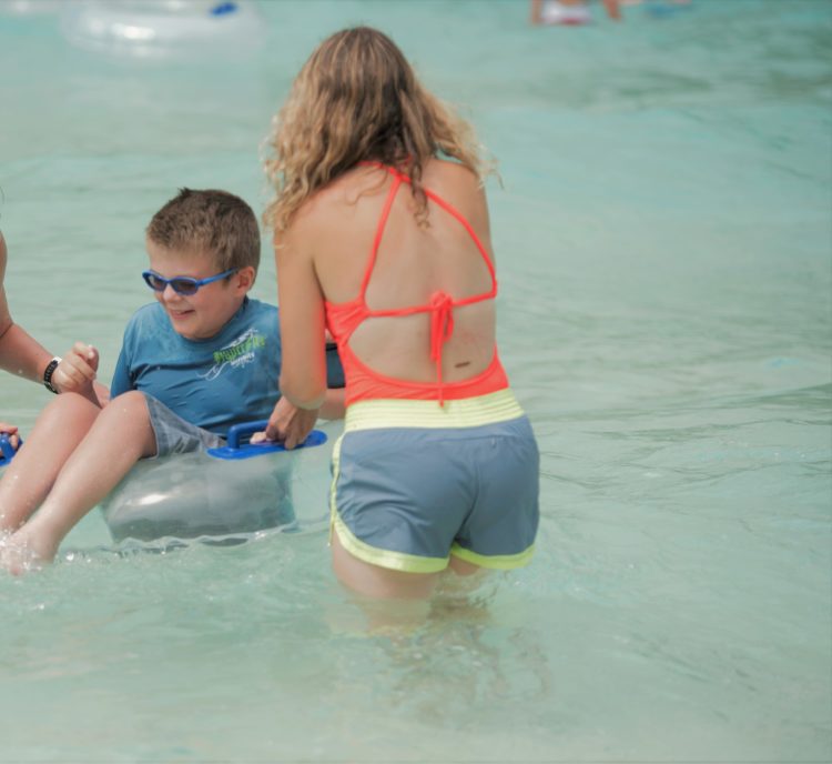 connor and his mom smiling in the water