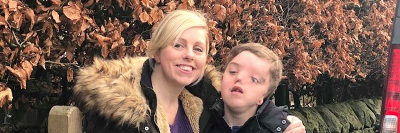 Why It's Hard to Let My Son With a Disability Grow Up Charlie and Harry Besick holding on to Harry's suitcase as he gets ready to go on his overnight trip.