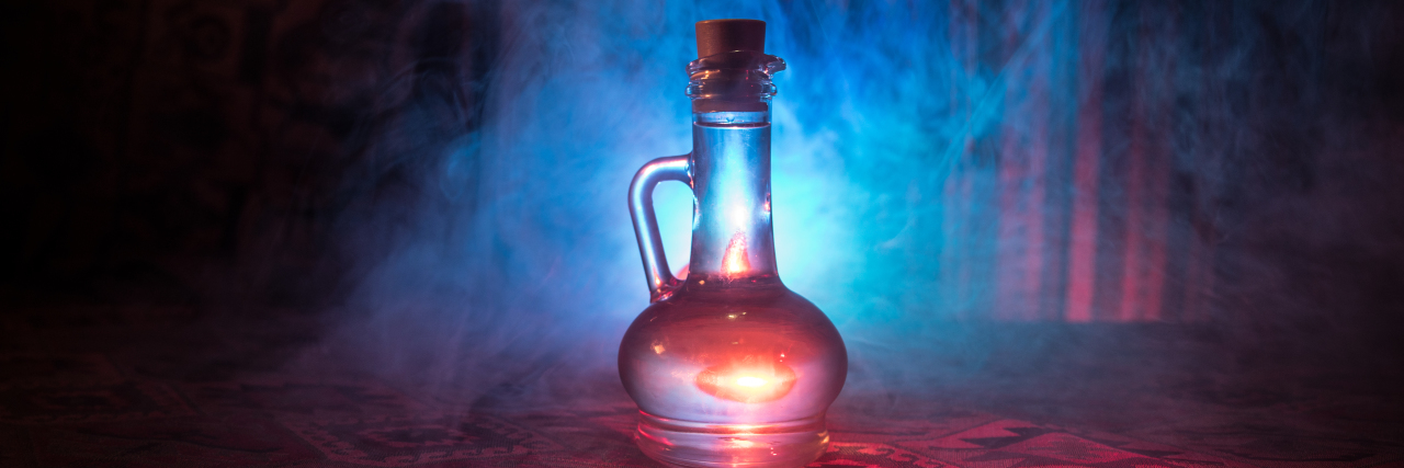 Would You Want a Cure for Your Disability? Glass bottle filled with magic potion.