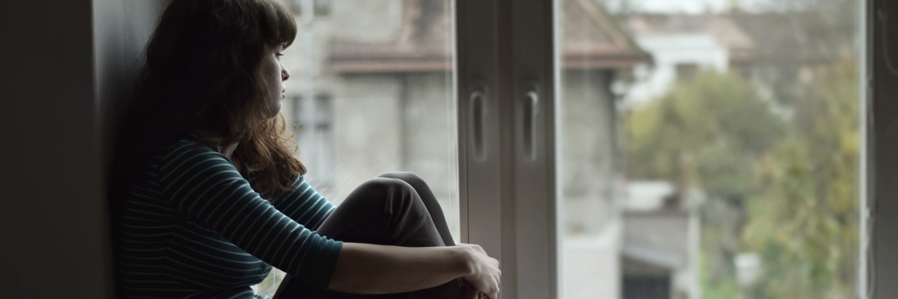 What Grief Has Taught Me sad woman sitting at the window