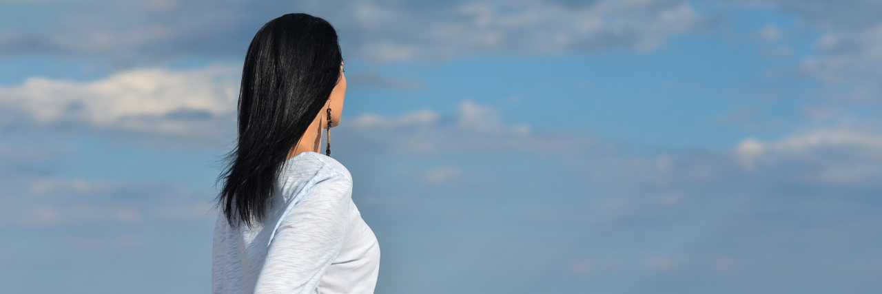 To the Friend Who Stopped Talking to Me After My Baby Died a woman is relaxing on a beach
