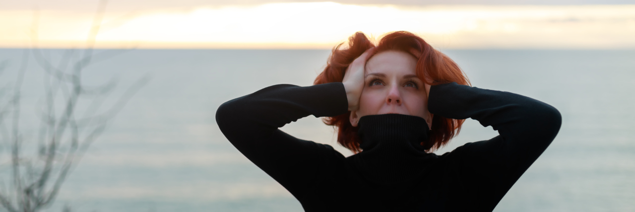 How I Channel My Anger Around My Son's 20th 'Angelversary' a woman with her hands on her head feeling despair