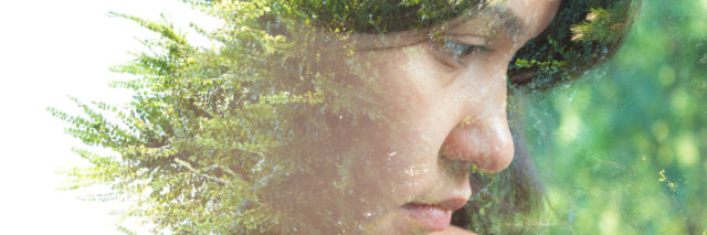 Double exposure portrait of woman with plants.