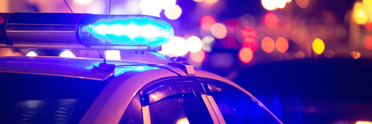 The Police Took Me to the Hospital After a Suicide Attempt Police car at night, lights on