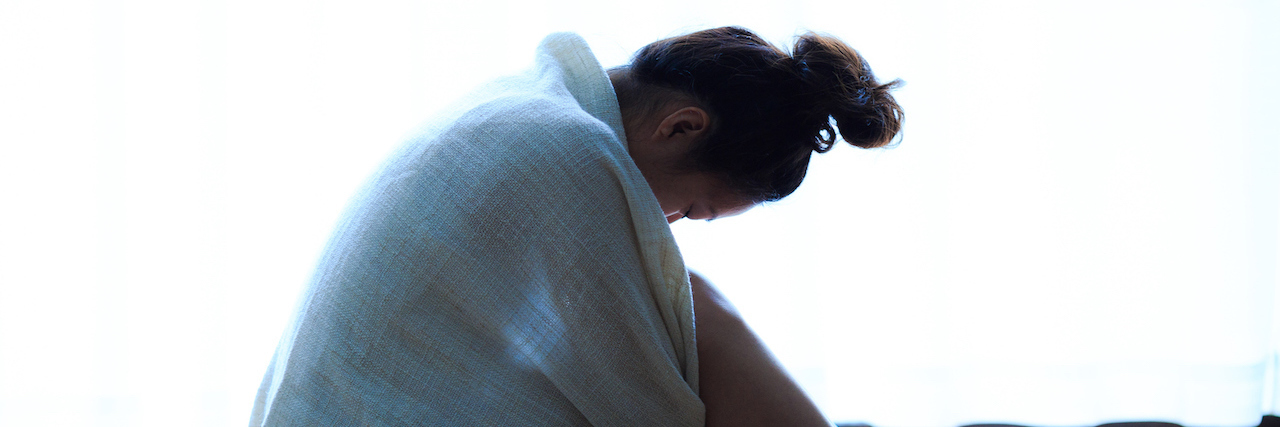 When You Think Your Family Would Be Better Off Without You A woman sitting on the floor with a blanket around herself