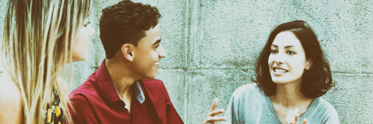 How to Make Friends With an Autistic Person Three friends talking outdoors.