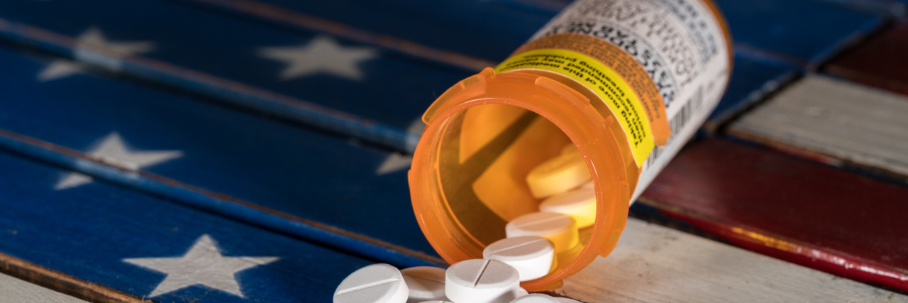 Senators Introduce Legislation to Limit Opioid Prescriptions to 7 Days Oxycodone is the generic name for a range of opoid pain killing tablets. Prescription bottle for Oxycodone tablets and pills on wooden USA flag