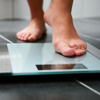 a person's feet stepping on the scale