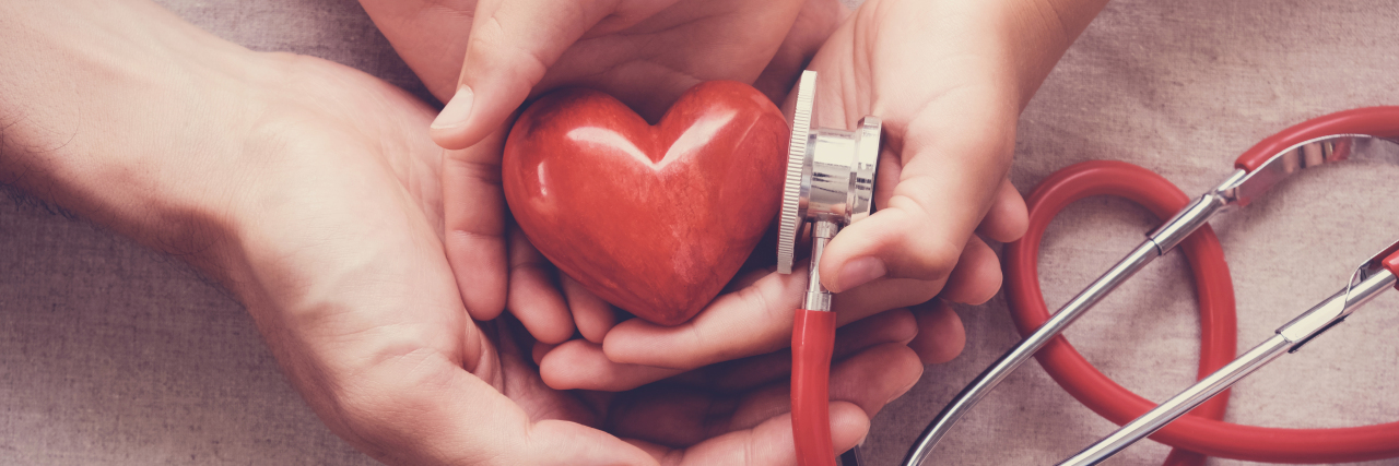 Growing Up With Hypoplastic Left Heart Syndrome child and adult holding red heart with stethoscope