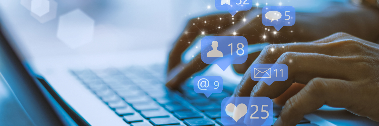 How Social Media Monitoring Would Harm People on Disability Benefits Woman using social media on laptop.