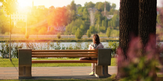 Being Born With a Disability Has Actually Enhanced My Life young woman sitting on bench near a lake