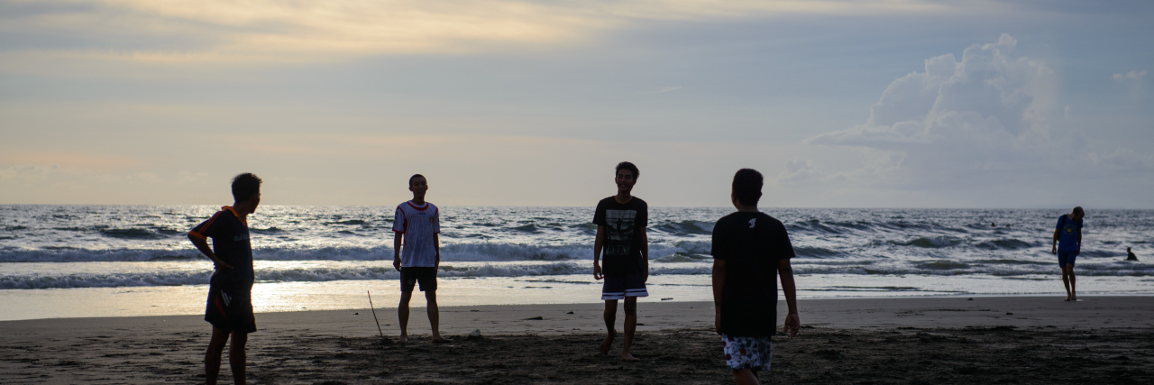 Supporting Autistic Children in Social Interactions Kids playing soccer on the beach.