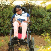 Kerstin sitting outside in her wheelchair.
