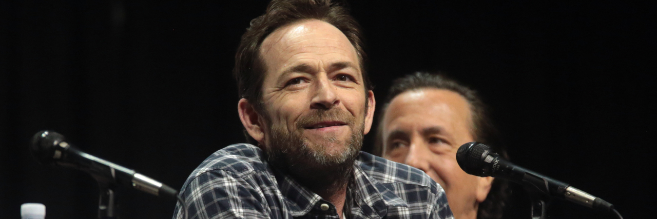 Image of Luke Perry speaking on a panel.