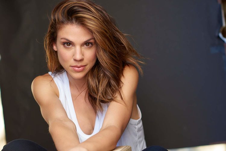 kate mansi white shirt looking at camera