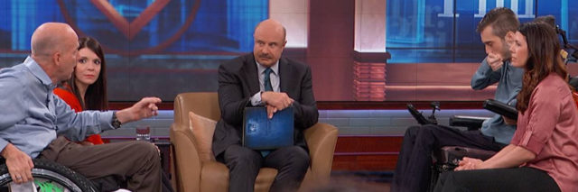 Dr. Phil sitting between two interabled couples. Both male partners are in wheelchairs. Their female partners are sitting next to them.