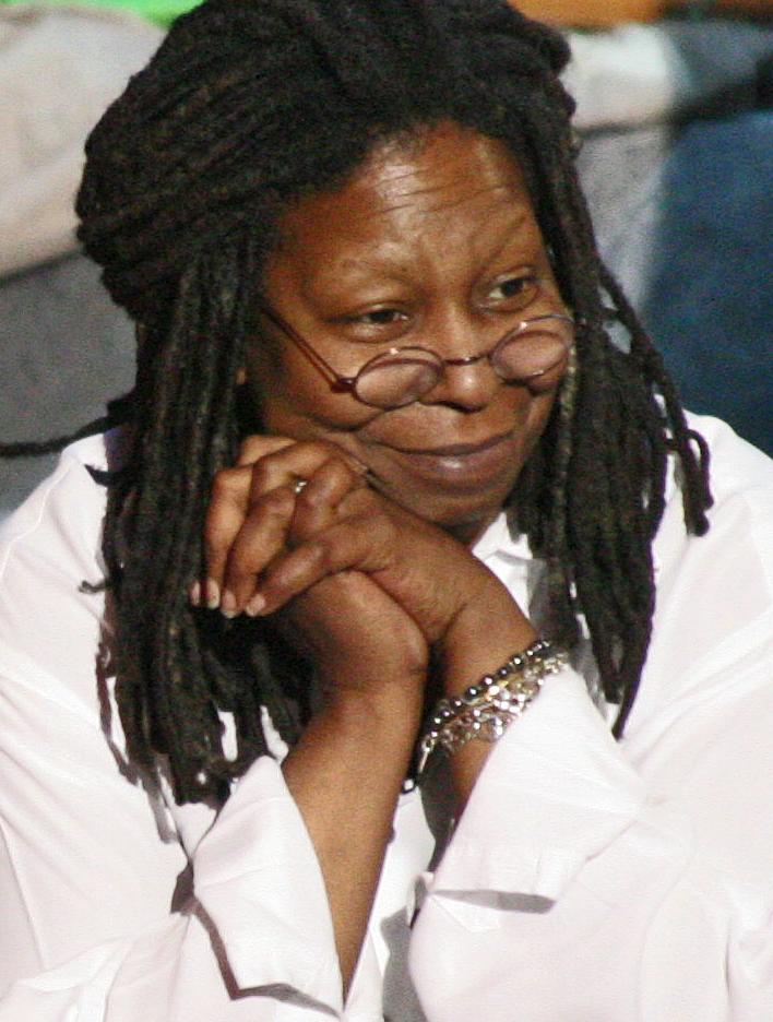 whoopi goldberg white shirt hands under chin