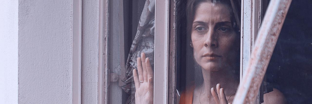 What Does It Mean to Be 'Normal' With Bipolar photo of sad middle aged woman looking out of window