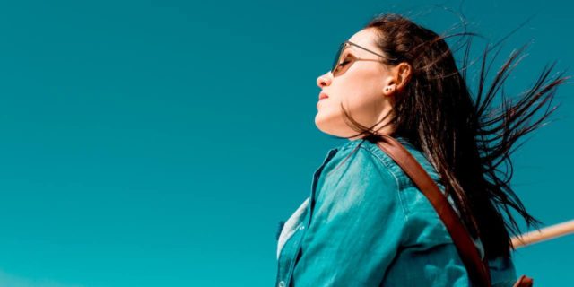 I Didn’t Know My Brain Could Bleed: Coping With a Cavernous Angioma Diagnosis woman wearing sunglasses looking at blue sky