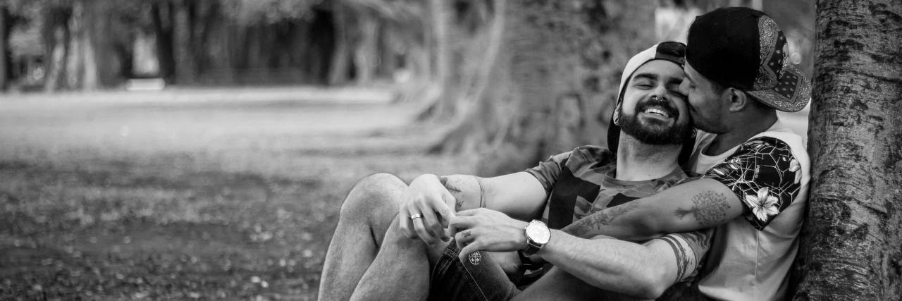 Relationship Goals Help Couples Get Strong gay couple sitting next to tree hugging