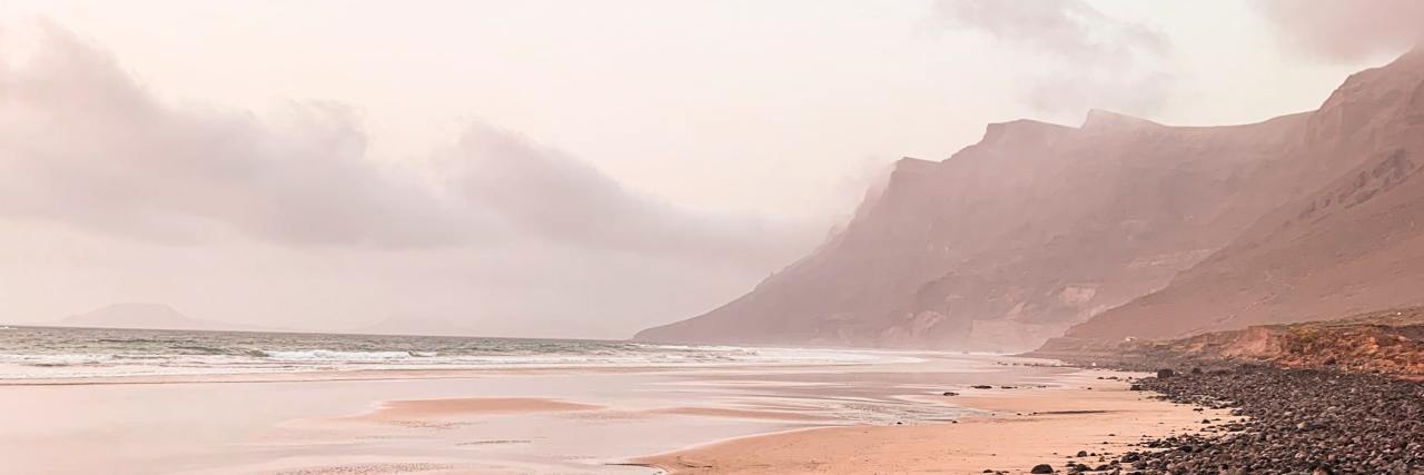 Why Eating Disorder Treatment Is Wrong About 'Healthy' Food and Bodies photo of black rocky beach in morning sunlight