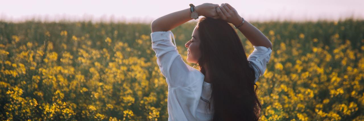 How to Stop Caring When People Don’t Like You woman in field of yellow flowers