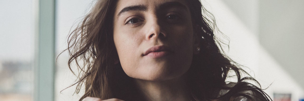 7 'Signs' That Let Me Know I Need Help With My Mental Health woman looking at camera