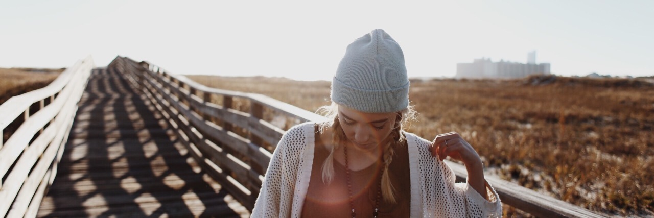 Facing Judgment With Chronic Illness: What to Do woman walking on bridge