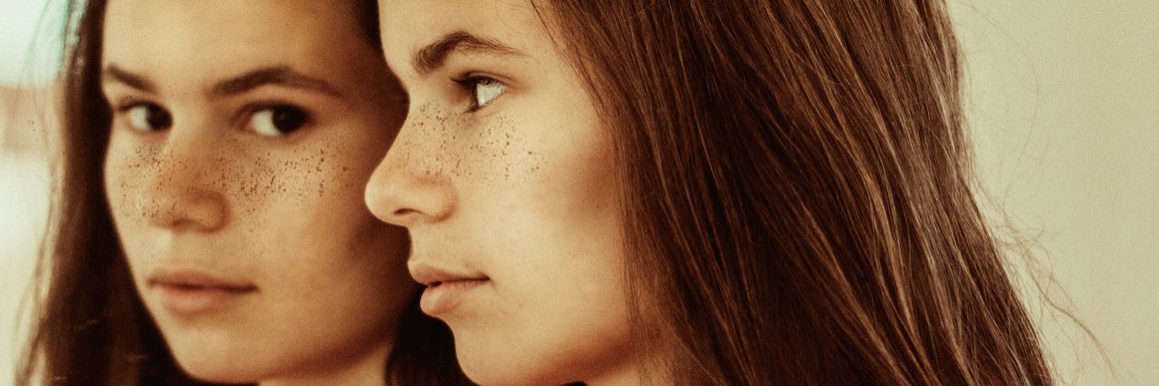 A Big Myth About Childhood Abuse A woman and her reflection in the mirror