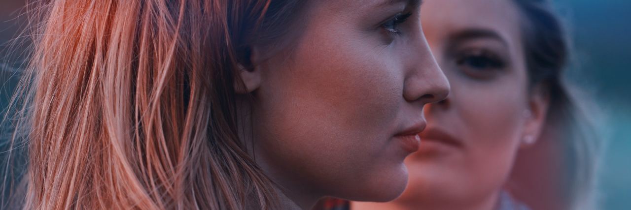 Mental Health First Aid as a Person With Suicidal Thoughts photo of two women, one in side view, one face on behind her