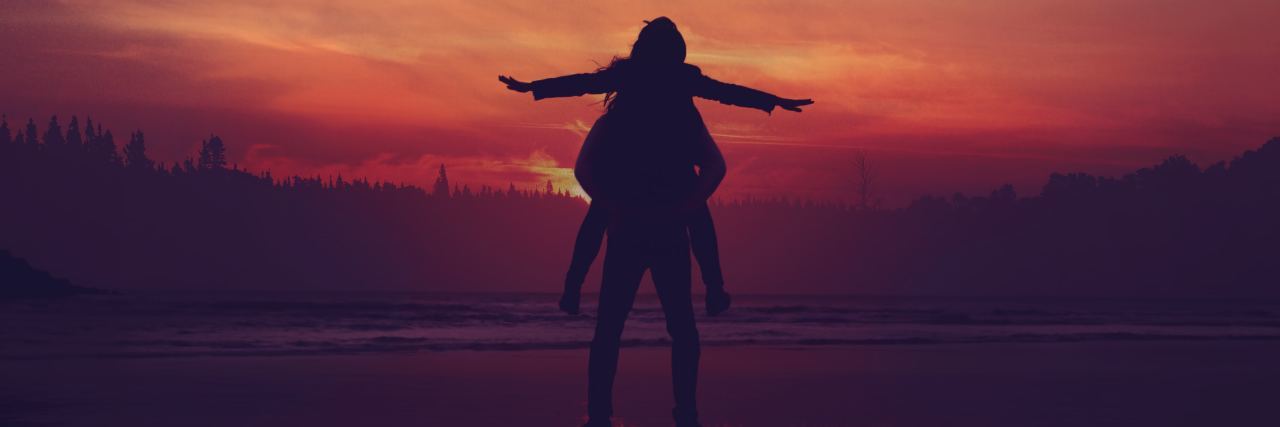photo of two people silhouetted against sunset with one on the others' shoulders