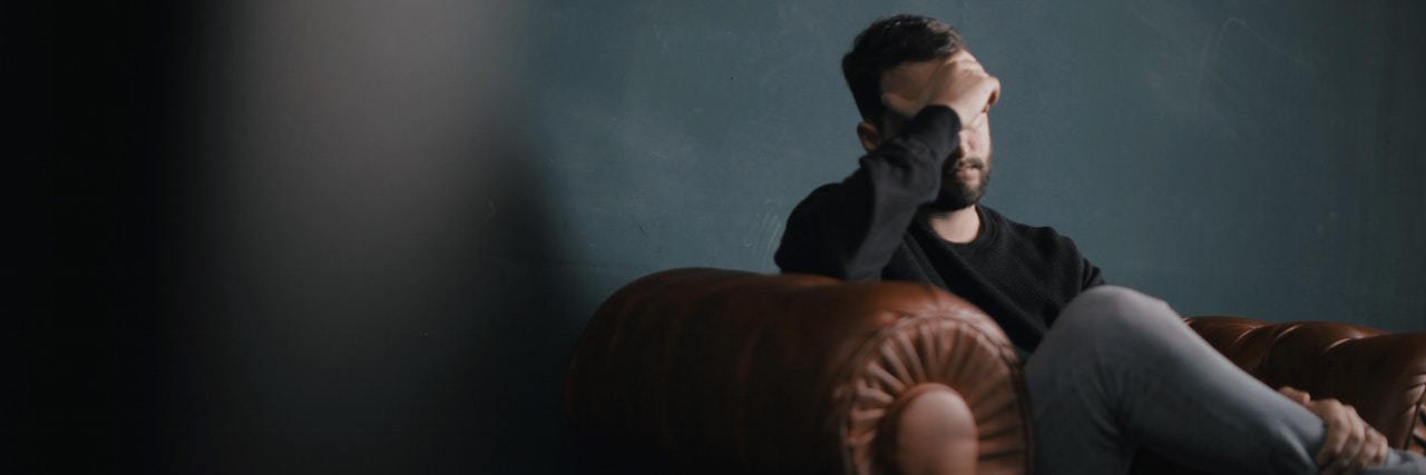 PTSD and Your Brain Man sitting with head in his hand