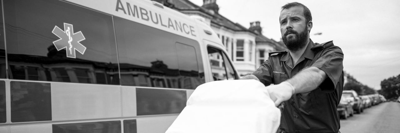 How Paramedics Should Treat People With Chronic Pain paramedic with stretcher next to ambulance