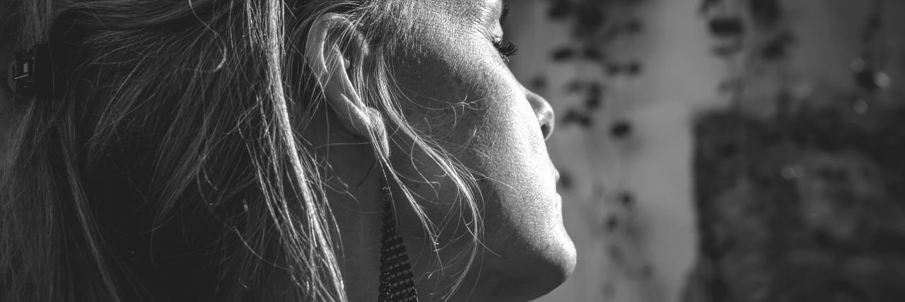 How Can I Help My Depressed Teen? black and white photo of teen with light hair and eyes closed facing away