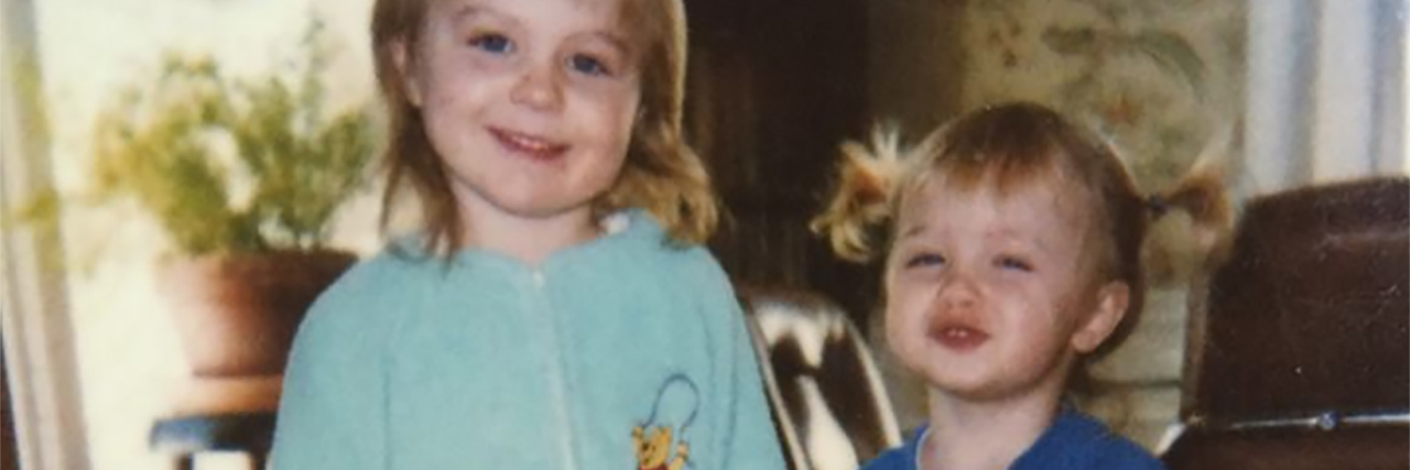 Remembering Child Abuse Through Nightmares photo of two young children in onesies holding teddy bear