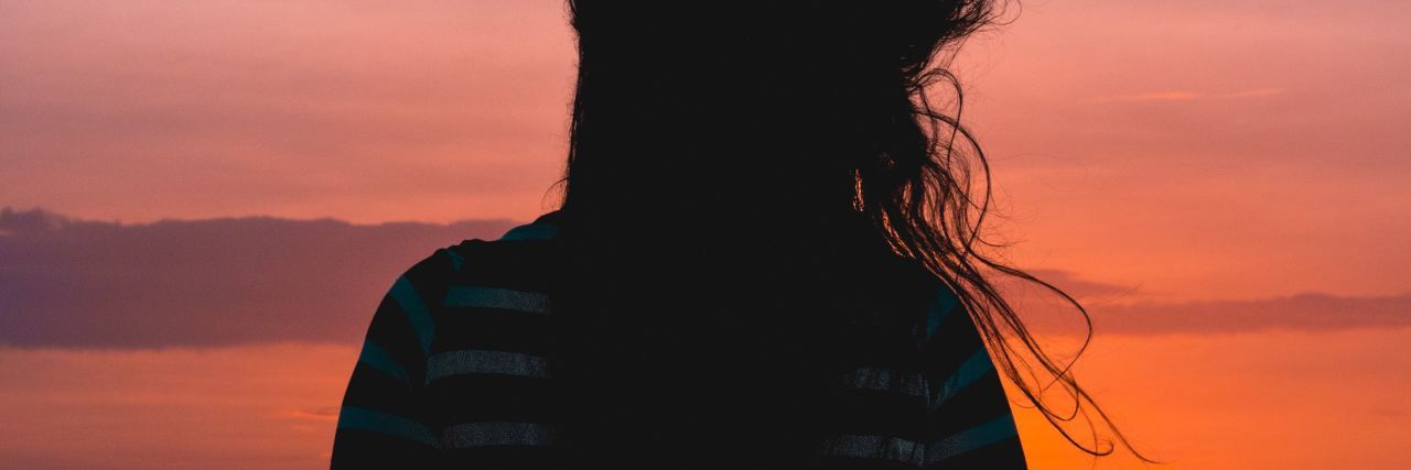What Life After OCD Treatment Is Really Like photo of woman silhouetted against colourful sky at sunset