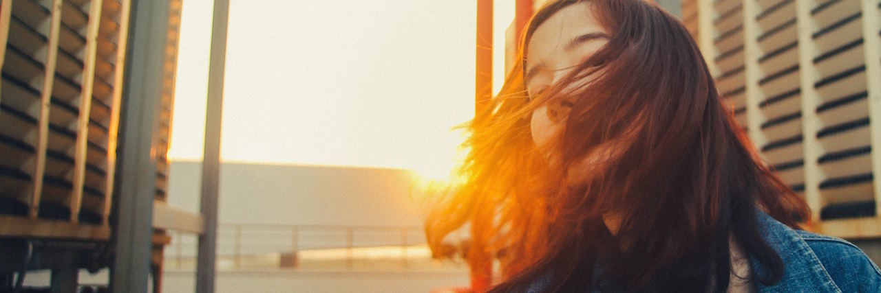 What Being Sick Made Me Realize About Loneliness A woman on a rooftop